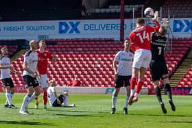 Rotherham United keeper Viktor Johansson is caught by the elbow by Barnsley rival Carlton Morris en route to the Reds player scoring in Saturday's controversial game at Oakwell. PICTURE: BRUCE ROLLINSON
