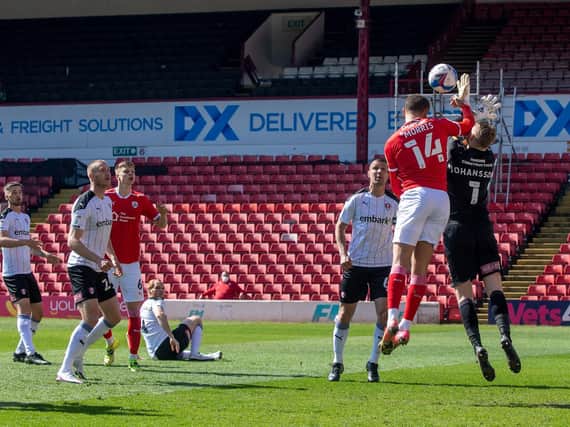 Rotherham United keeper Viktor Johansson is caught by the elbow by Barnsley rival Carlton Morris en route to the Reds player scoring in Saturday's controversial game at Oakwell. PICTURE: BRUCE ROLLINSON