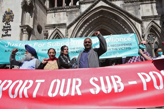 Postmasters celebrate their fight for justice outside the Royal Courts of Justice.