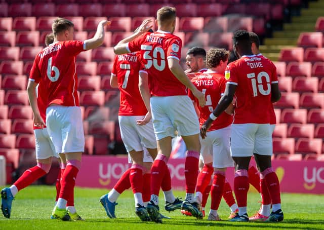 RRemarkable ride: Barnsley players celebrate Carlton Morris’s controversial goal against Rotherham on Saturday that eventually sealed a play-off spot. (Picture: Bruce Rollinson)