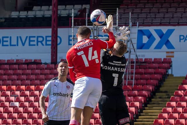 Flashpoint: Carlton Morris collides with Viktor Johansson before heading in Barnsley's opening goal against Rotherham depriving the Millers of their keeper for tonight's game at Brentford (Picture: Bruce Rollinson)
