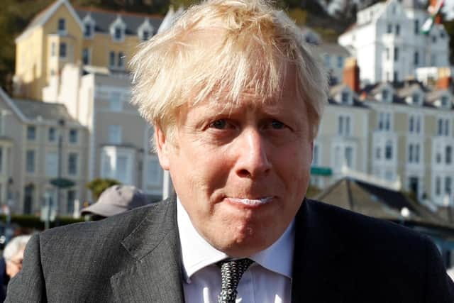 Boris Johnson took time out to eat an ice cream during a visit to Wales as he becomes embroiled in a series of controversies.