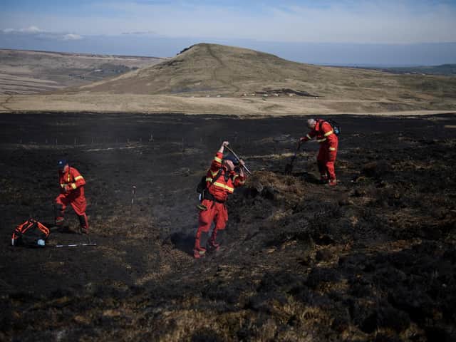 Firefighters tackle any resurgence of a moor fire on Marsden Moor