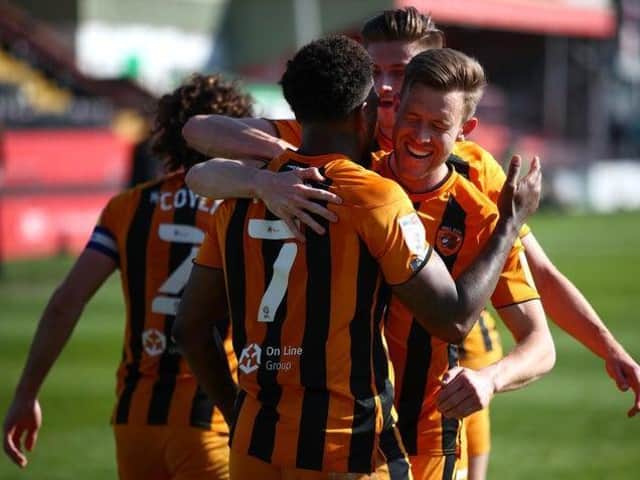 CELEBRATIONS: Hull City's players lap up Mallik Wilks's winning penalty at Lincoln.