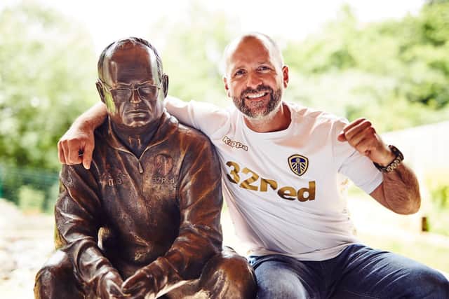 Leeds artistic creator Tony Clark (right) sits alongside the statue of Leeds United manager Marcelo Bielsa.