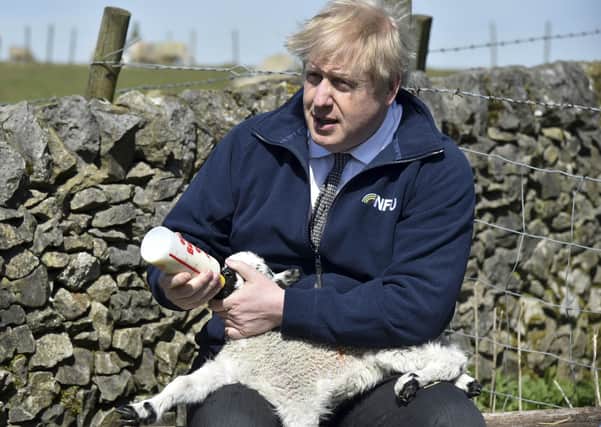 Boris Johnson during a farm visit to Derbyshire where he met NFU chairman Minette Batters.