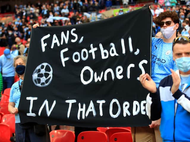 Fans hold up a banner protesting against the European Super League ahead of the Carabao Cup Final at Wembley Stadium, London.