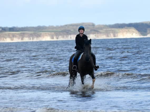 The Milners' daughter Lauren riding Whisky on the beach at Fraisthorpe