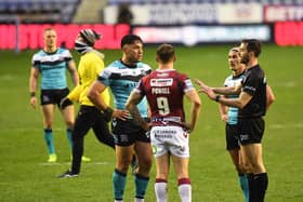 Referee James Child brings Hull captain Danny Houghton and Wigan skipper Sam Powell together to hear Hull's Andre Savelio, far left, report his allegation of a racist remark being made against him. (JONATHAN GAWTHORPE)