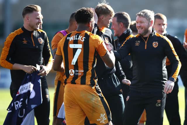 Mission accomplished: Mallik Wilks, Grant McCann and Hull City celebrated promotion to the Championship last week. (Picture: PA)