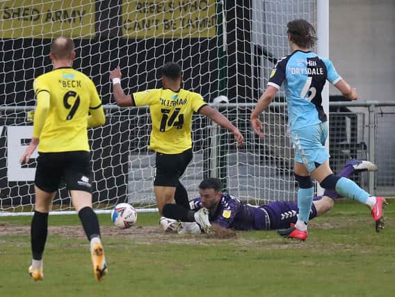 Harrogate Town forward Brendan Kiernan scores from close range to complete his hat-trick in Friday night's 5-4 success over Cambridge United. Pictures: Getty Images
