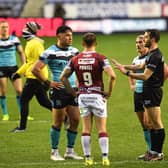 Referee James Child brings Hull captain Danny Houghton and Wigan skipper Sam Powell together to hear Hull's Andre Savelio allege a racist remark was made against him by Wigan's Tony Clubb. (JONATHAN GAWTHORPE)