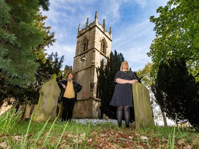 Pictured (left to right) Victoria Ryves, a curator, from Heritage Doncaster, with Nick Crouch, a researcher for Heritage Doncaster's Changing The Record project, in the grounds of St Michaels Church, Rossington, near Sheffield. Image James Hardisty