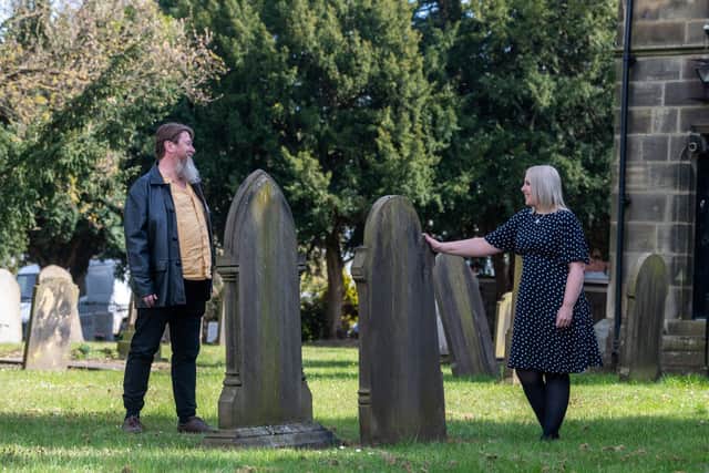 Pictured (left to right) Victoria Ryves, a curator, from Heritage Doncaster, with Nick Crouch, a researcher for Heritage Doncaster's Changing The Record project, in the grounds of St Michaels Church, Rossington, near Sheffield. Image James Hardisty