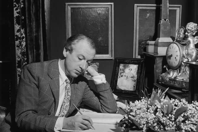 Sir Cecil Beaton writing at his desk in 1947. (Photo by George Konig/Keystone Features/Getty Images)