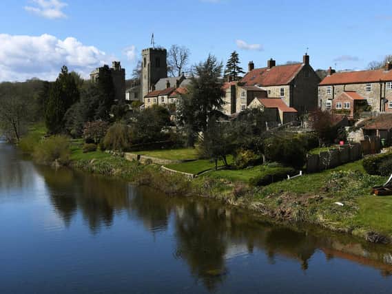St Nicholas Church and The Marmion Tower stand on the banks of the River Ure, in the village of West Tanfield, near Ripon. Picture: Jonathan Gawthorpe