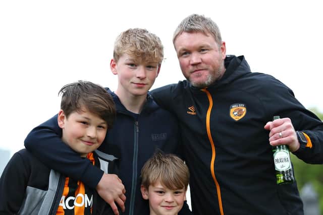 Tigers chief Grant McCann toasts his team's title triumph alongside members of his family.