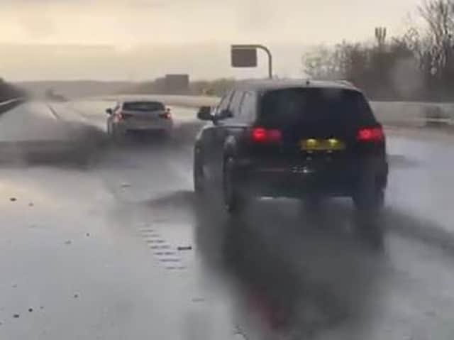 The video shows cars driving through standing water on the M62