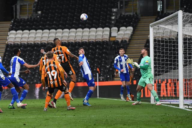 Jumping Josh: Josh Magennis, heads home the Tigers’ third goal in the title-clinching victory over Wigan Athletic. Pictures: Jonathan Gawthorpe