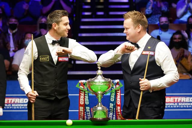 PLAYING SAFE: England's Mark Selby (left) and England's Shaun Murphy bump elbows before the start of their World Snooker Championship final at The Crucible, Sheffield. Picture: Zac Goodwin/PA