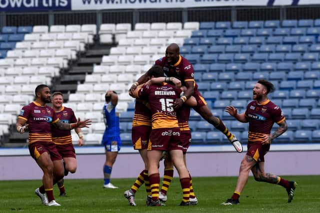 Huddersfield Giants' Lee Gaskell is mobbed by his team-mates after scoring a late, winning drop goal to sink Leeds Rhinos. Picture: Simon Hulme