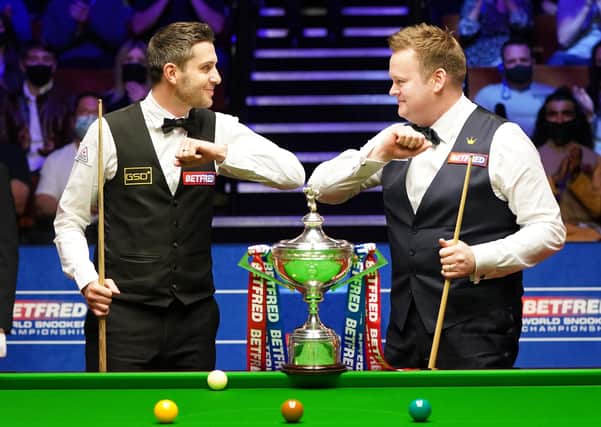 Mark Selby and Shaun Murphy at the start of the final of the Betfred World Snooker Championships.