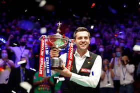 Mark Selby poses for photos after winning the Betfred World Snooker Championship. Picture: Zac Goodwin/PA