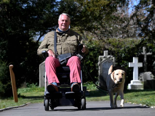 Andrew Newton and his service dog, Alvin, outside St John's Church in Sharrow where his wife is the vicar.