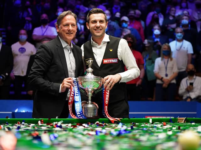 Helping hand: Mark Selby, right, poses with coach Chris Henry after winning the title at The Crucible. (Picture: Zac Goodwin/PA)