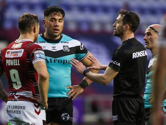 Hull's Andre Savelio, second from left, makes a complaint to referee James Child and captains Sam Powell, of Wigan and Danny Houghton during last week's game. Picture by Alex Whitehead/SWpix.com.
