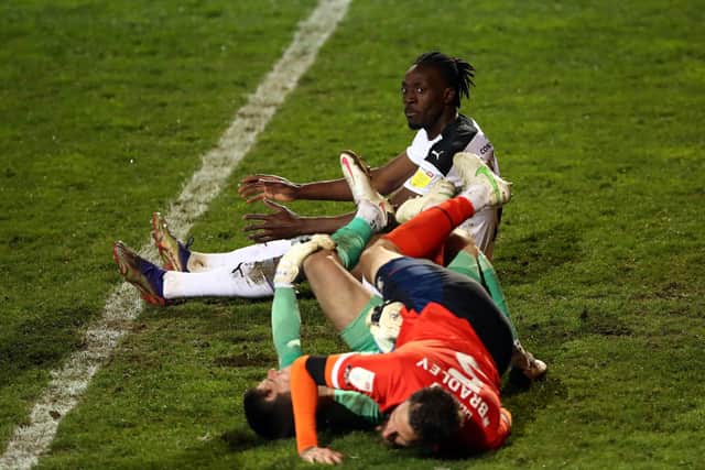 Rotherham United's Freddie Ladapo looks on as Luton Town's Sonny Bradley and Simon Sluga collide whilst defending. Pictures: PA.