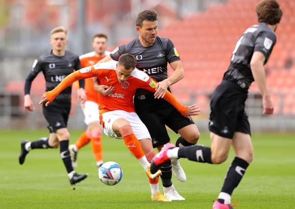 Blackpool's Jerry Yates (left) and Doncaster Rovers' Andrew Butler battle for the ball. Picture: PA.