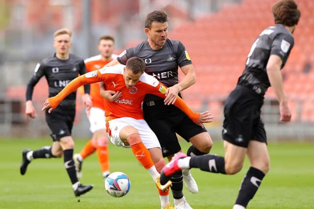 Blackpool's Jerry Yates (left) and Doncaster Rovers' Andrew Butler battle for the ball. Picture: PA.