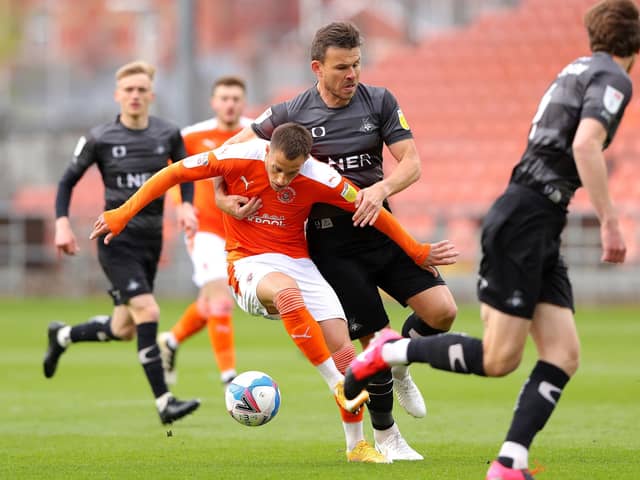 Blackpool's Jerry Yates (left) and Doncaster Rovers' Andrew Butler battle for the ball. Picture: PA.