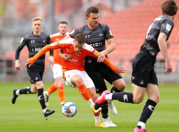 Blackpool's Jerry Yates (left) and Doncaster Rovers' Andrew Butler battle for the ball. Picture: PA.