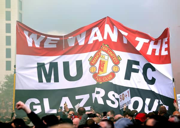 Demonstrating: Fans hold up a banner as they protest against the Glazer family, owners of Manchester United, at Old Trafford.