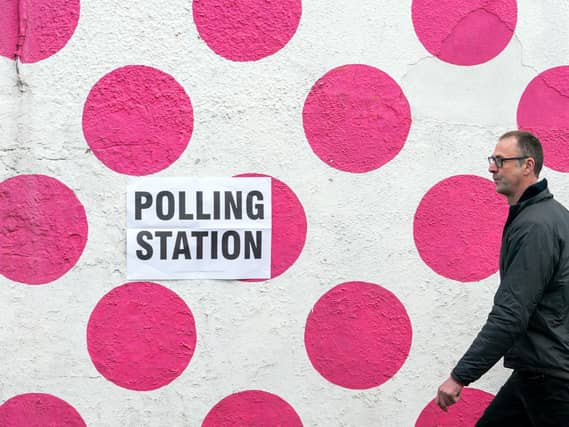 A man walks past a polling station in the Bank View Cafe, Sheffield