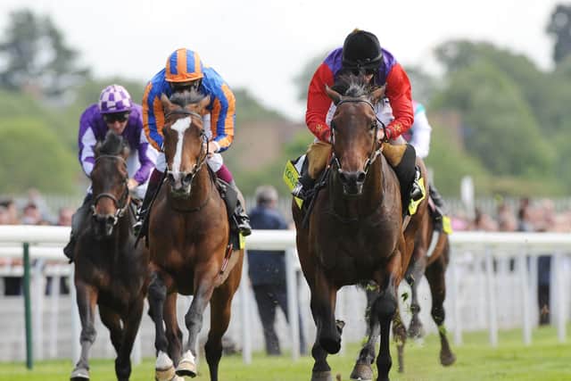 Carlton House and Ryan Moore surge clear of the favourite Seville in the 2011 Dante Stakes at York.