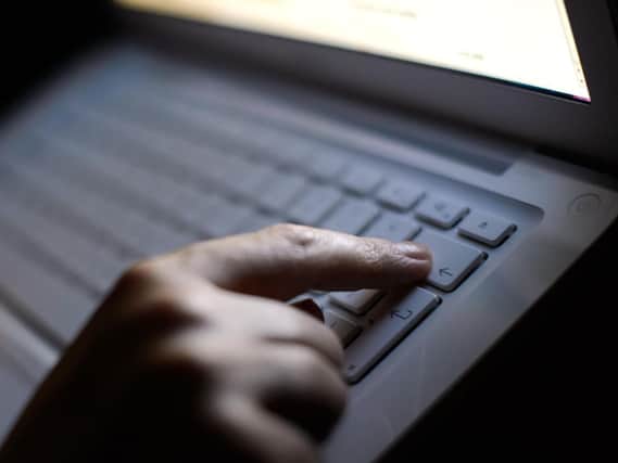 File photo dated 06/08/13 of a person using a laptop. The UK must use new laws to ensure online platforms have a legal responsibility to protect users from an "avalanche" of scams, a coalition of groups has warned the Government. Photo: PA