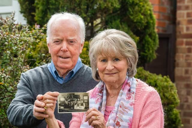 Mike Ulyatt and his wife, Ann, with a postcard featuring two of Ann's relatives killed during the blitz. (Picture: James Hardisty)..
