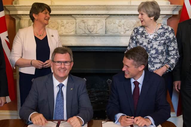 Prime Minister Theresa May stands with DUP leader Arlene Foster (left), as DUP MP Sir Jeffrey Donaldson (left) and Parliamentary Secretary to the Treasury, and Chief Whip, Gavin Williamson, smile inside 10 Downing Street, London, after the DUP agreed a deal to support the minority Conservative government in 2017.