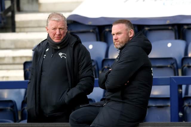 UNDER PRESSURE: Derby County manager Wayne Rooney (right) speaks to technical director Steve McClaren. Picture: Martin Rickett/PA