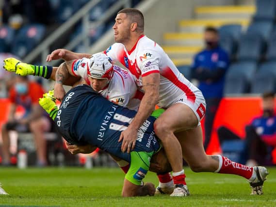 Huddersfield Giants' Kenny Edwards is tackled by St Helens. (BRUCE ROLLINSON)