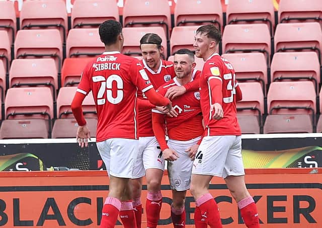 Barnsley’s Conor Chaplin (centre) celebrates scoring their second goal against Championship champions Norwich City at Oakwell. Picture: John Clifton/Sportimage