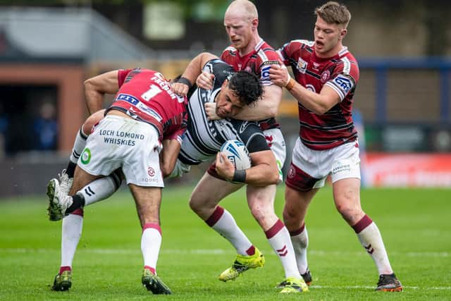 Hull FC's Andre Savelio is met by the Wigan defence (TONY JOHNSON)