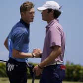 Friendly foes: Cole Hammer, right, of the USA team, greets Ben Schmidt. Pictures: AP Photo/Gerald Herbert