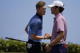 Friendly foes: Cole Hammer, right, of the USA team, greets Ben Schmidt. Pictures: AP Photo/Gerald Herbert