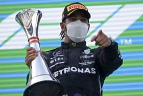 Mercedes driver Lewis Hamilton of Britain celebrates on the podium after winning the Spanish Formula One Grand Prix at the Barcelona Catalunya racetrack in Montmelo, just outside Barcelona, Spain, Sunday, May 9, 2021. (AP Photo/Emilio Morenatti)