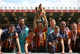 Hull City’s Richie Smallwood (centre) and team-mates celebrate with the League One trophy. Picture: PA