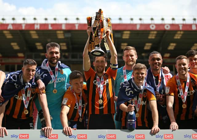 Hull City’s Richie Smallwood (centre) and team-mates celebrate with the League One trophy. Picture: PA